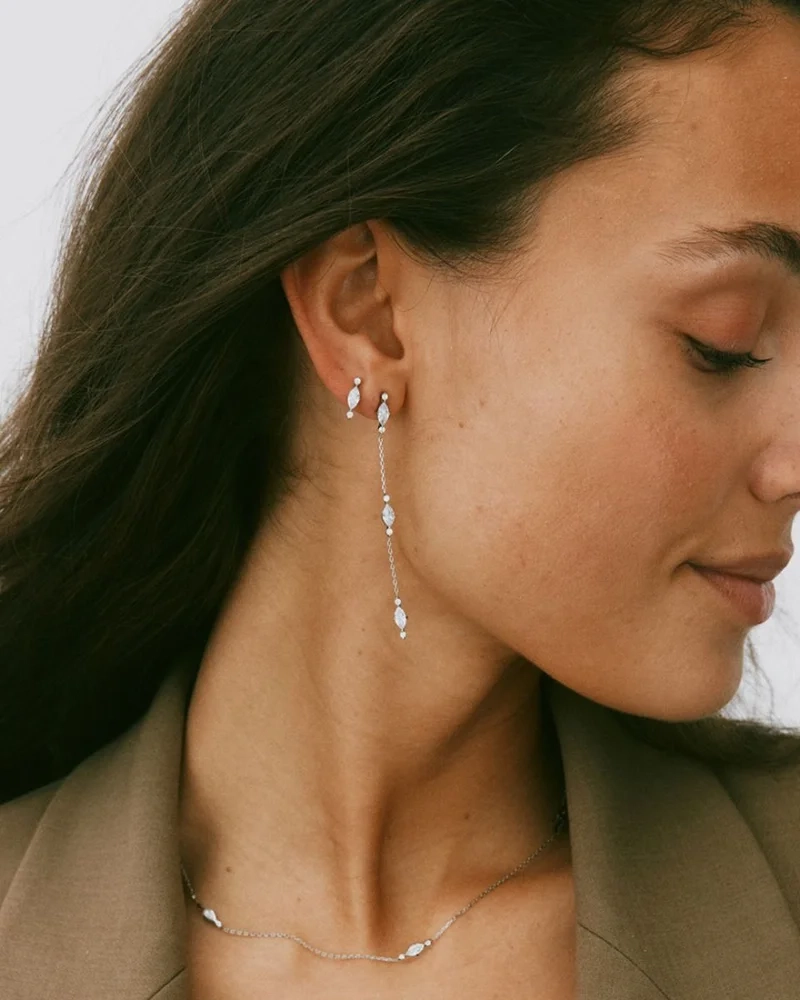 Trinny Earrings i rostfritt stål med tre grupper av gnistrande cubic zirconia-stenar på en polerad ankarkedja