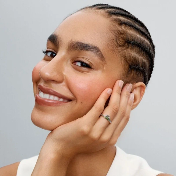 Prinsessring inspirerad av Disneyprinsessan Tiana med ljusgröna kristaller och kubisk zirkonia i liljeformad kudde. Tillverkad i sterlingsilver. Idealisk som personlig talisman.