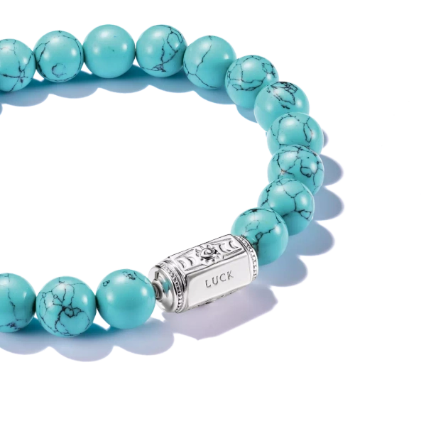 Armband Beads Turkos från Thomas Sabo med imiterade turkospärlor och silverdetalj med lyckosymboler.