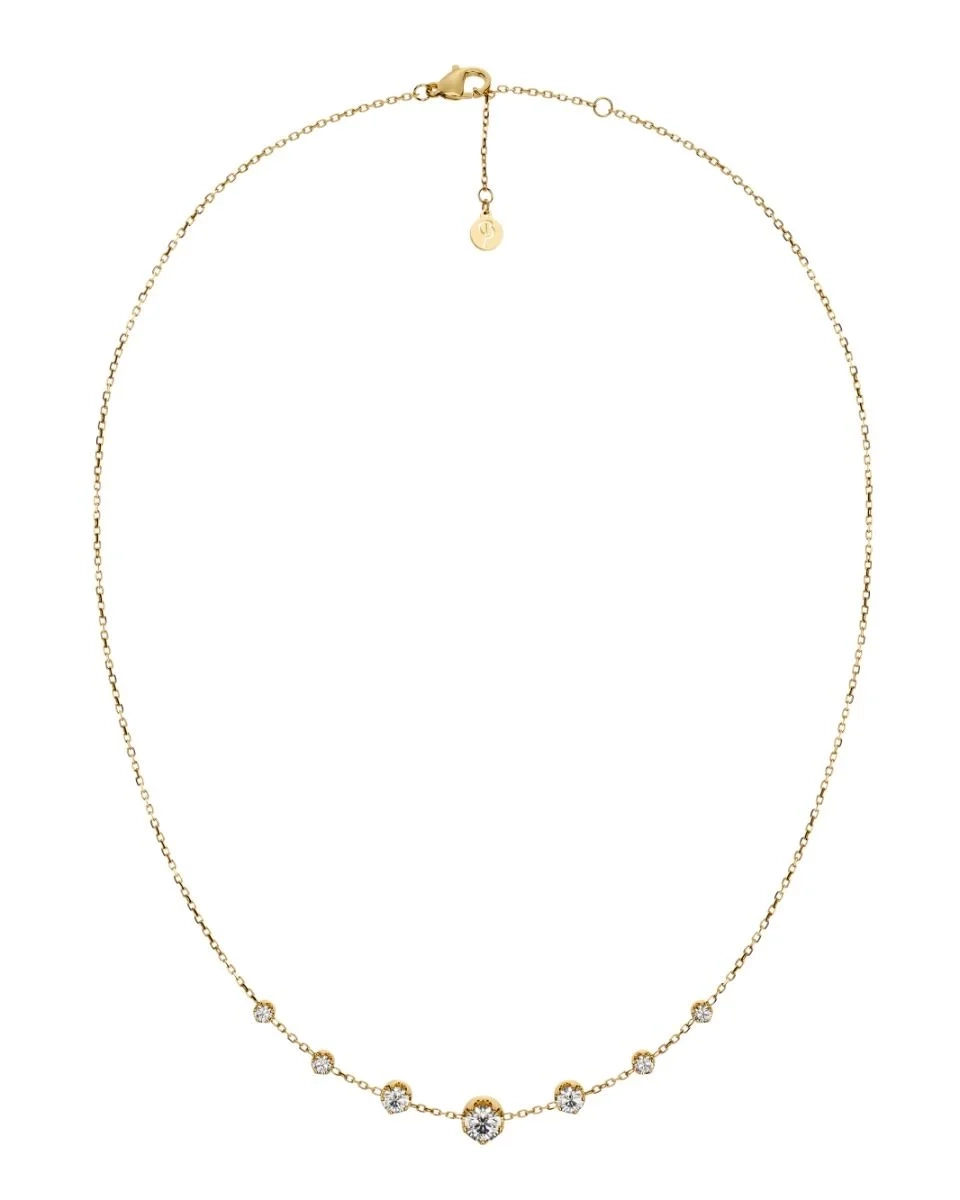 Guldpläterat halsband från Edblad med fyra gnistrande cubic zirconia-stenar i olika storlekar på en tunn kedja.