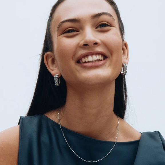 i polerat rostfritt stål med smäckra kedjor och generösa ringar