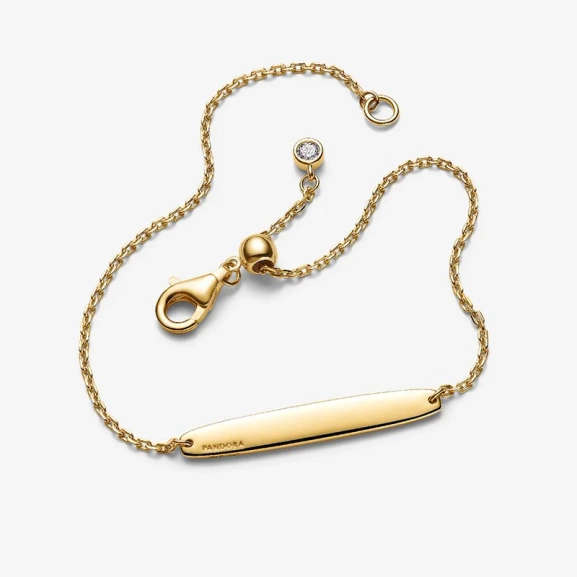Armband med Bricka Guld från Pandora Moments kollektionen med Cubic Zirconia stenar i 14 karat guldplätering. Skapa din unika stil och visa din sanna jag med detta eleganta smycke.