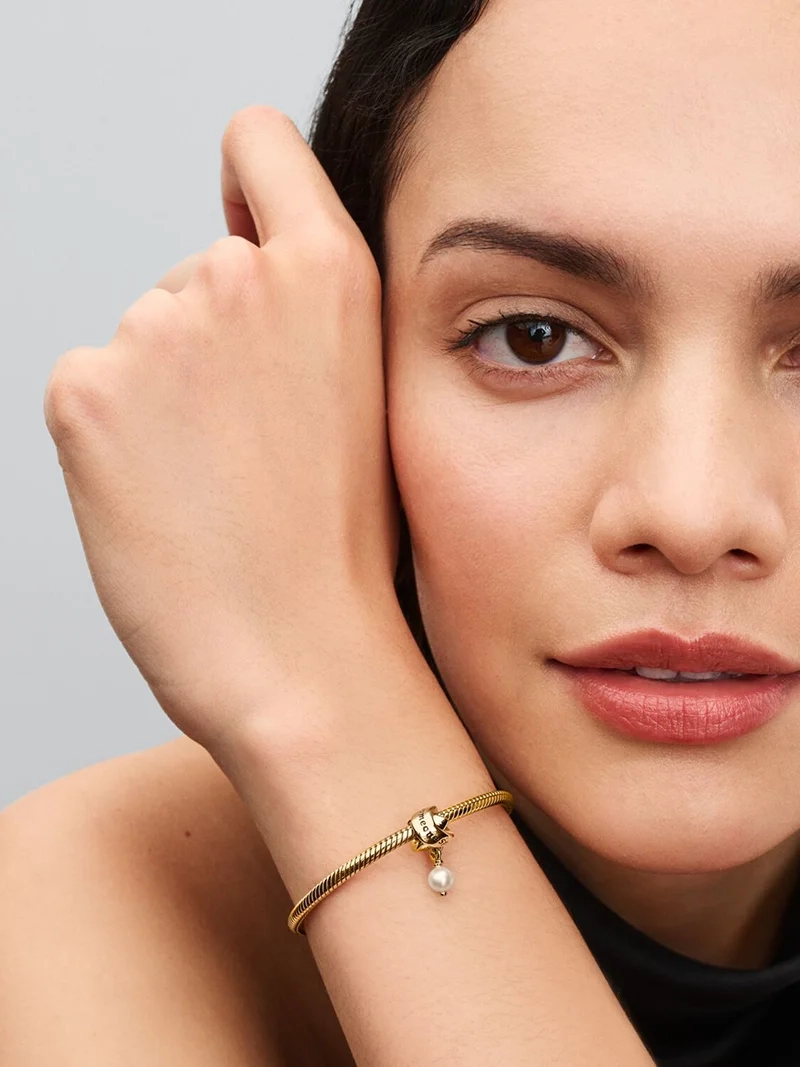 Pandora Moments Someone Special Pärla Berlock med 14 karat guldplätering och sötvattenspärla på svart emaljband.