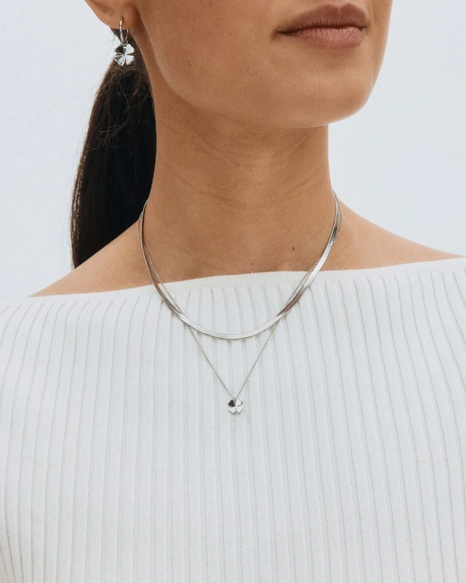 Halsband i polerat rostfritt stål med stilren fyrklöverberlock på tunn kedja från Edblads Lucky Mini-serie.