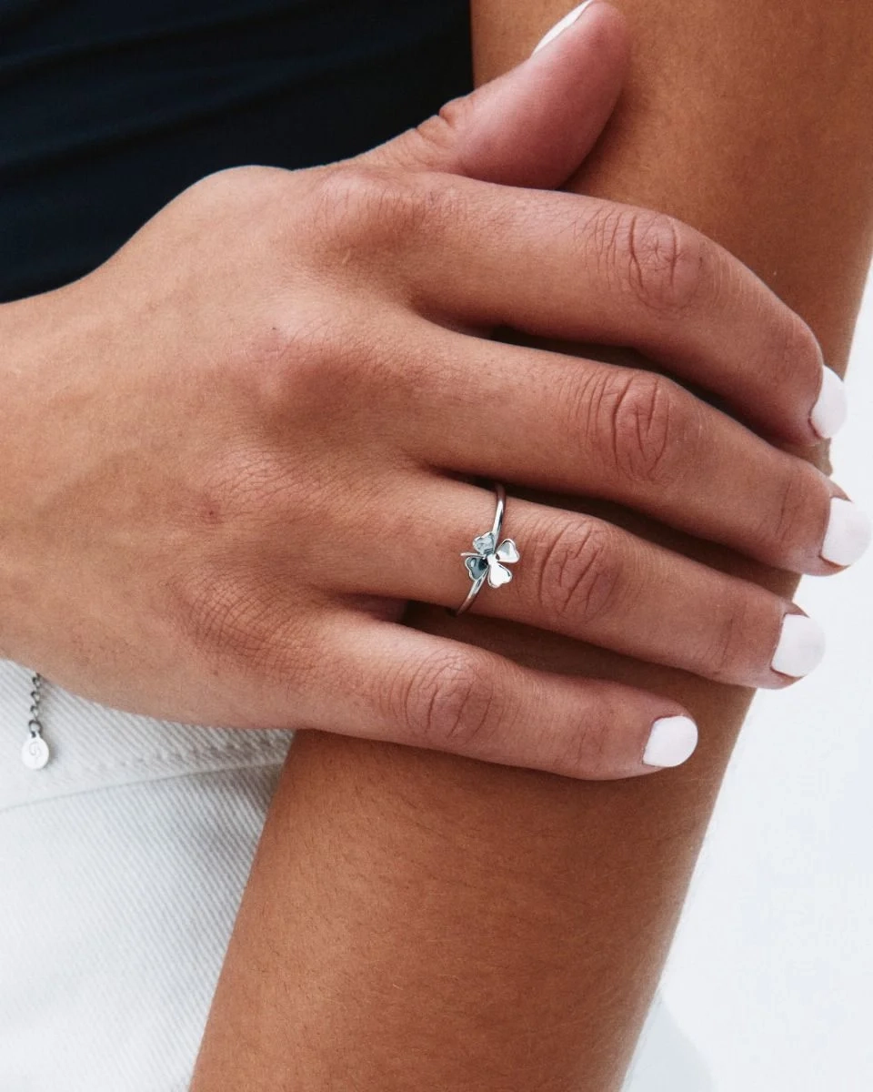 Elegant ring i polerat rostfritt stål med stiliserad fyrklöver